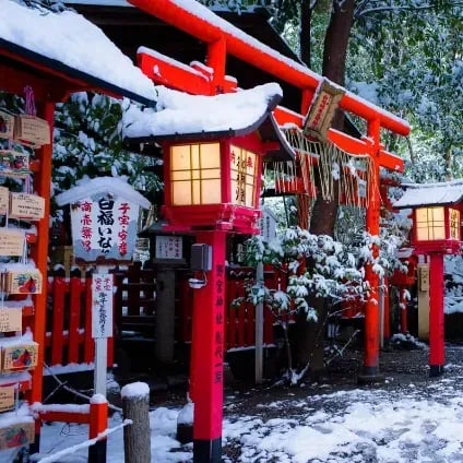 Snow-covered traditional Japanese shrine lanterns