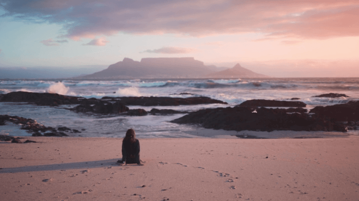 Person-on-beach-at-sunset-with-original-qulaity
