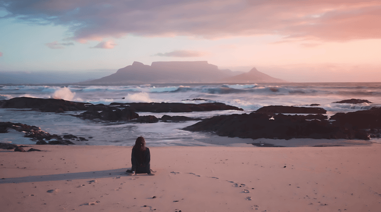 Person-on-beach-at-sunset-with-high-quality